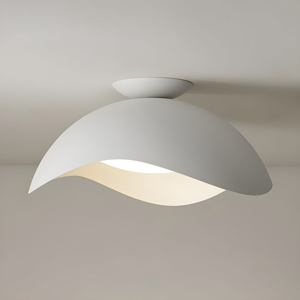 On a plain grey ceiling, this Clérachic wave ceiling light shows its rounded canopy and gently curved shade.