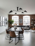 Multi-arm ceiling light with reflector shades on white background