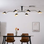 White spider ceiling light shown against a plain backdrop