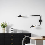 Wall sconce with slender black arm and conical shade detail