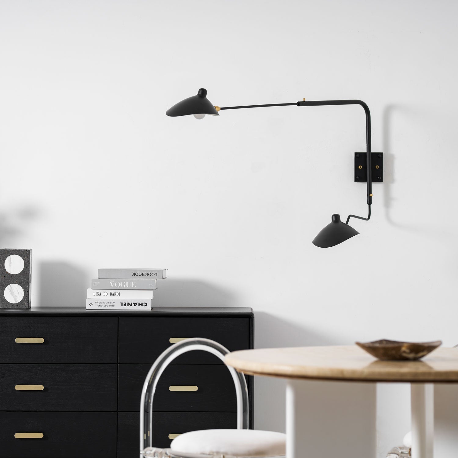 Wall sconce with extended arm shown in a minimalist room