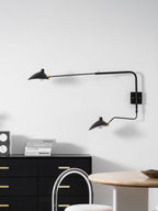 Black long-arm wall sconce with pivoting shade close view