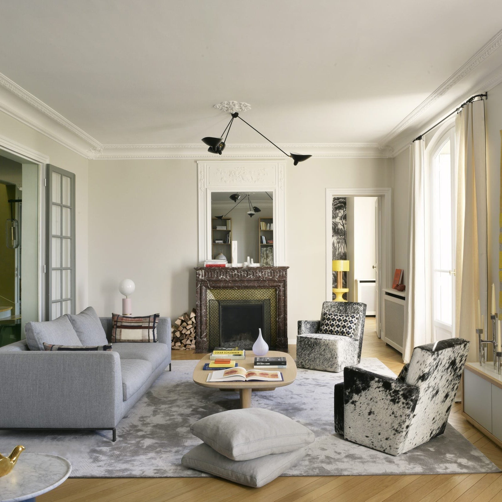 Three-arm spider ceiling light against a neutral wall