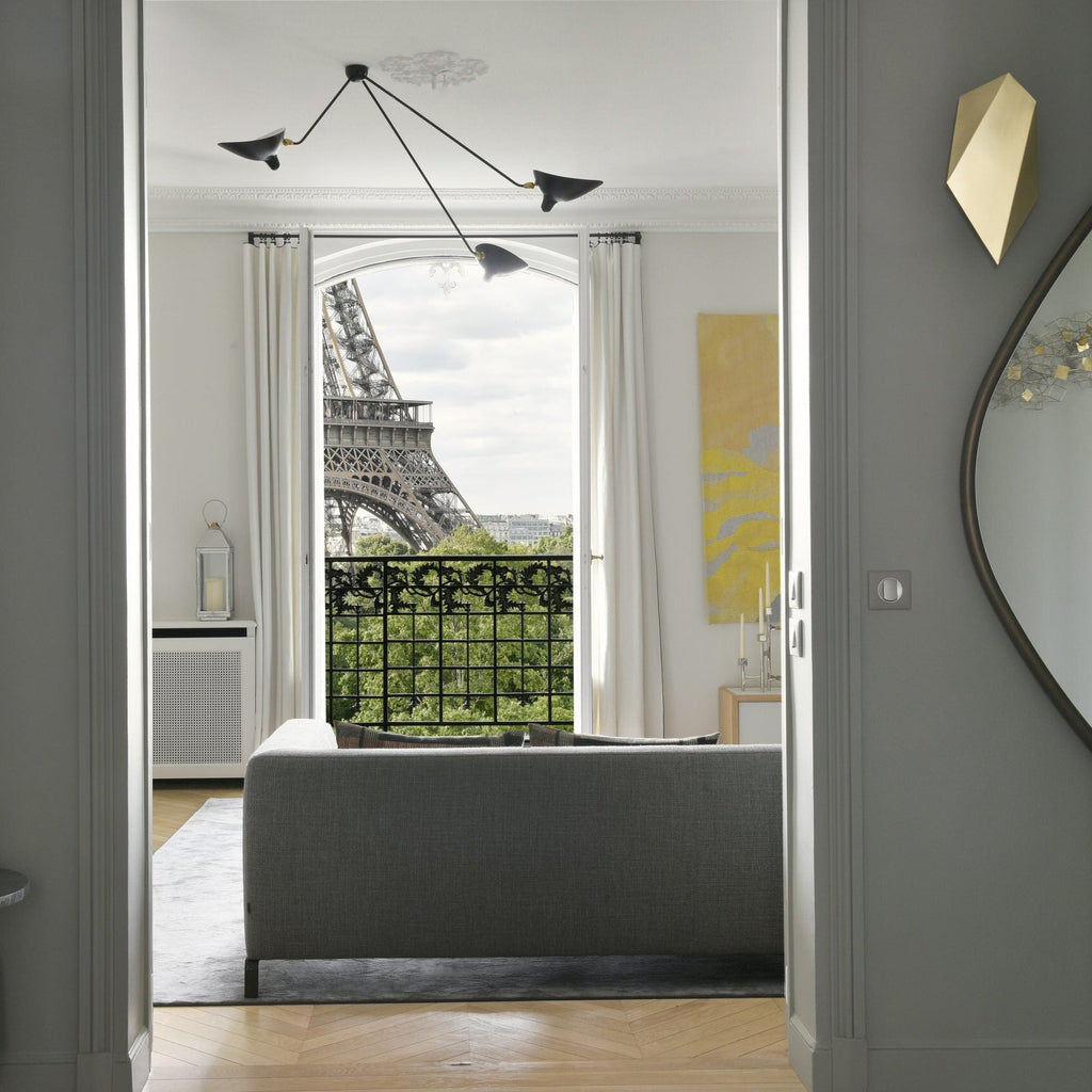 Spider ceiling lamp with arms angled toward a seating area