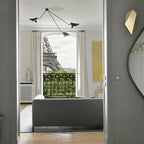 Spider ceiling lamp with arms angled toward a seating area