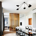 Spider ceiling lamp lit above an open living space
