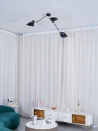 Spider ceiling lamp arms fanning out in a minimal room