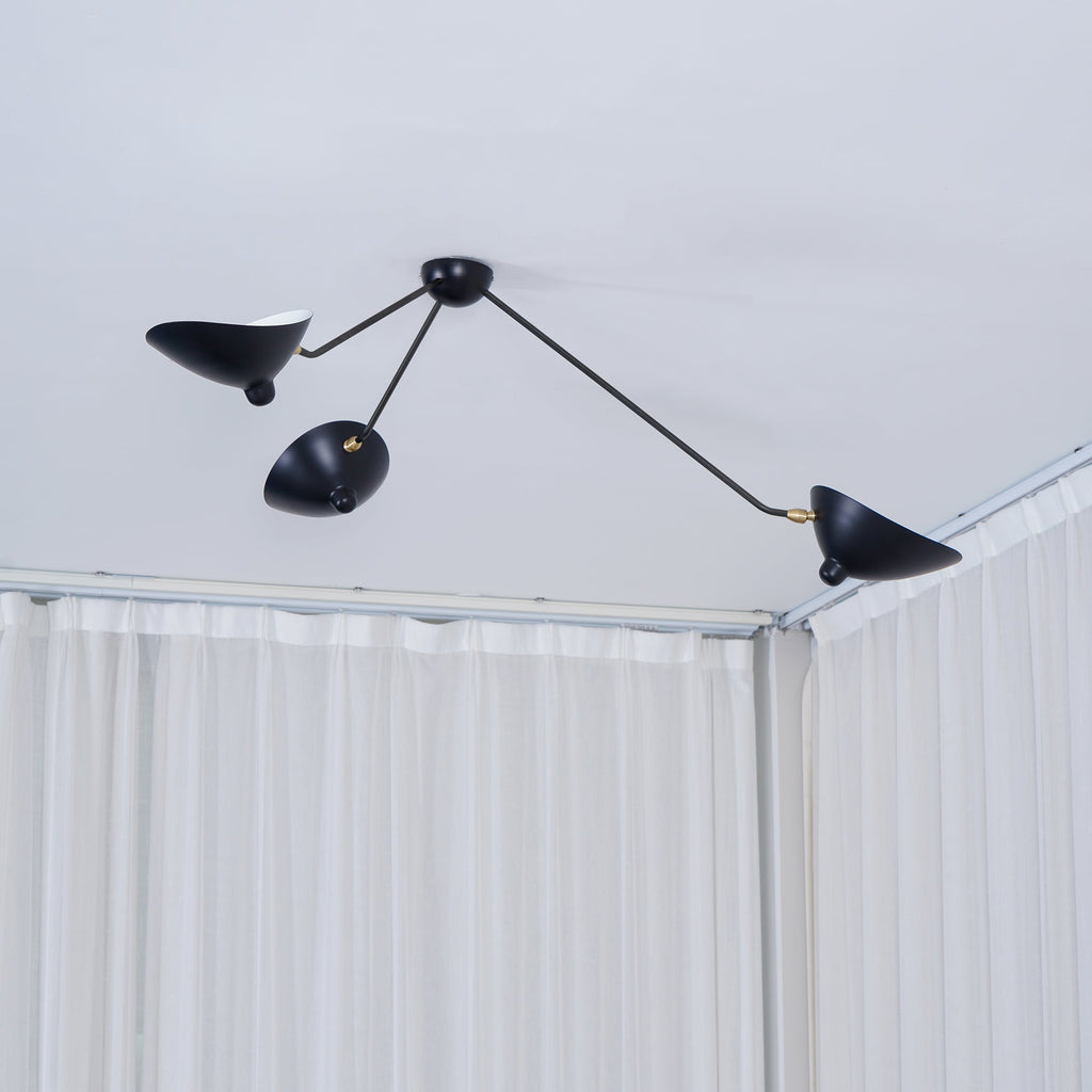 Spider ceiling light with reflectors tilted at varied angles