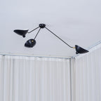 Spider ceiling light with reflectors tilted at varied angles