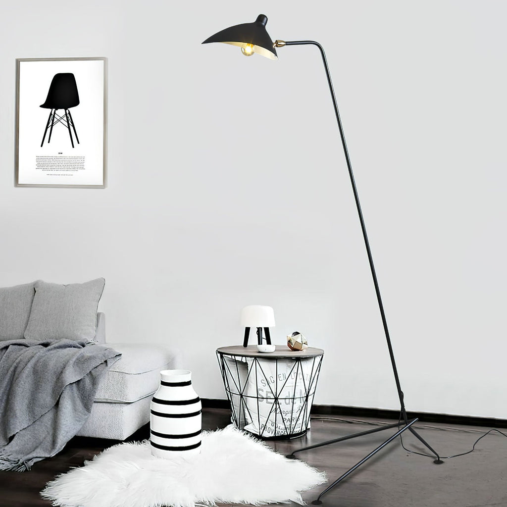 Sculptural floor lamp silhouette against a pale wall
