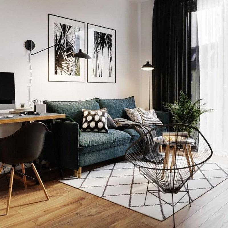 Plug-in wall lamp mounted above a sofa in a styled room