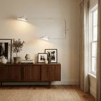 Long-arm wall sconce angled to show independent shade rotation