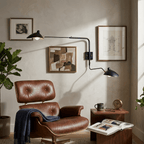 Spider wall sconce mounted beside a chair as reading light