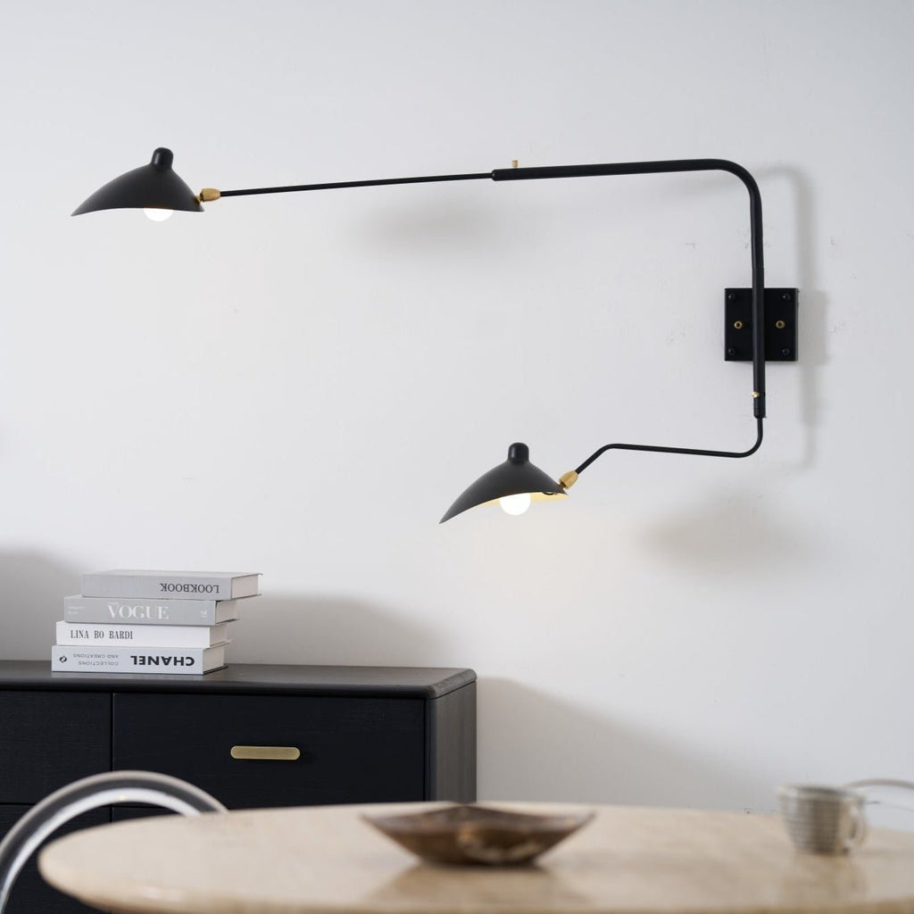 Long-arm wall sconce with rotating shade in a living space