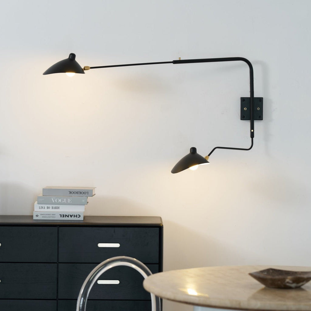 Two-arm wall sconce mounted high on an interior wall