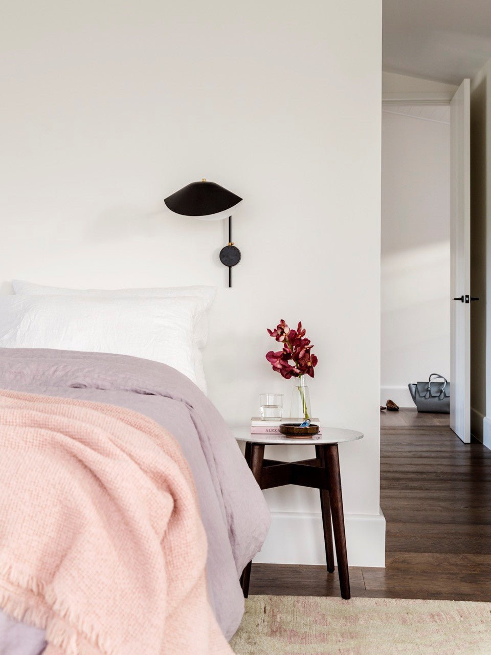 Long-arm wall sconce shown mounted in a contemporary interior