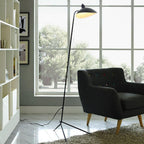 Single-arm floor lamp with conical shade tilted downward