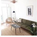 Spider floor lamp in a minimal interior beside a chair