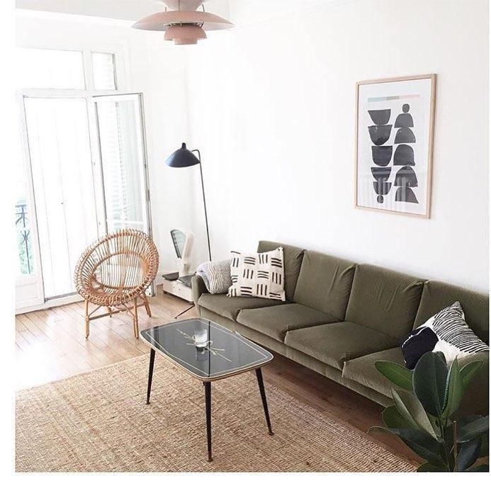 Spider floor lamp in a minimal interior beside a chair