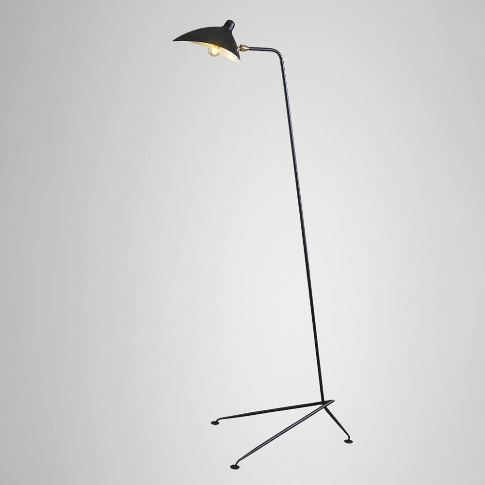 Floor lamp arm rotated to throw light onto a wall