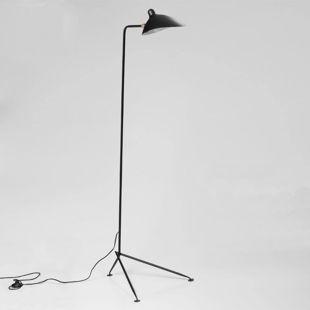 Black metal floor lamp tripod base on a wood floor