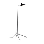 Black spider floor lamp angled over a lounge seating area