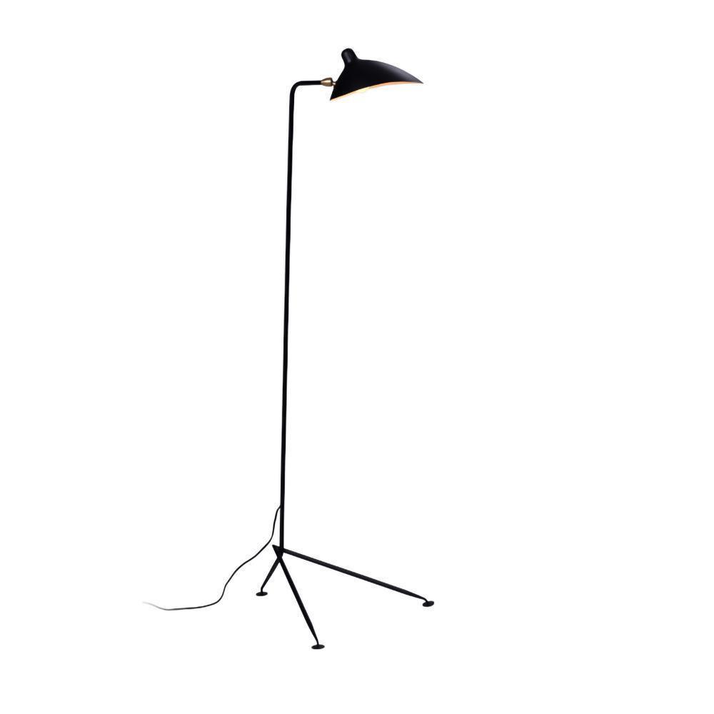 Black spider floor lamp angled over a lounge seating area