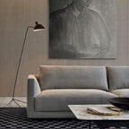 Black floor lamp arm extended over a side table