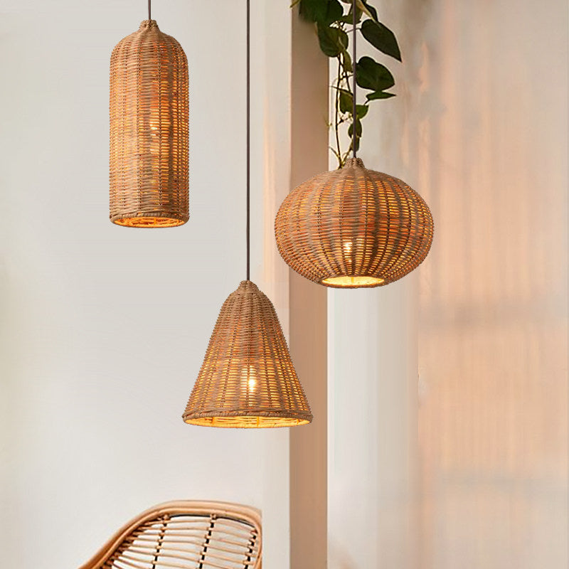 In a plant-filled corner, cylinder, cone, and pumpkin rattan Clérachic pendants cluster near a bright window.