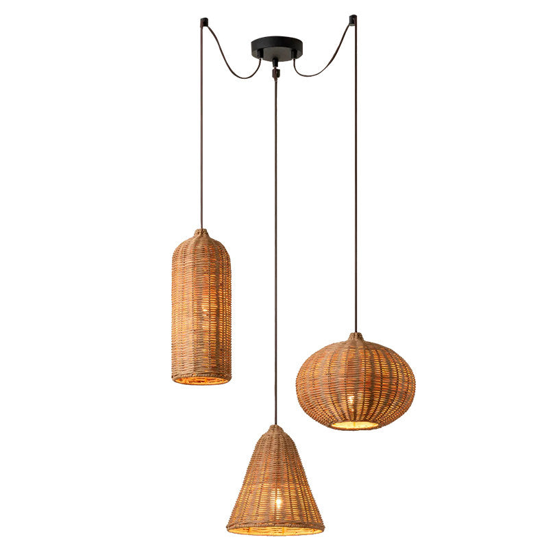 This single-canopy Clérachic cluster staggers a cylinder, a pumpkin-round, and a cone rattan shade at different depths.