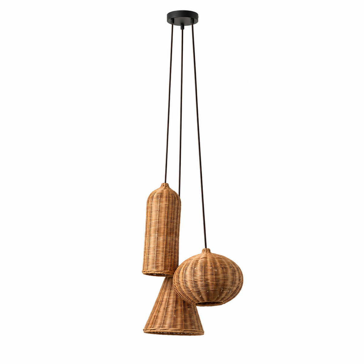 Cylinder, pumpkin, and cone rattan Clérachic shades hang from one canopy at staggered heights, each glowing warmly.