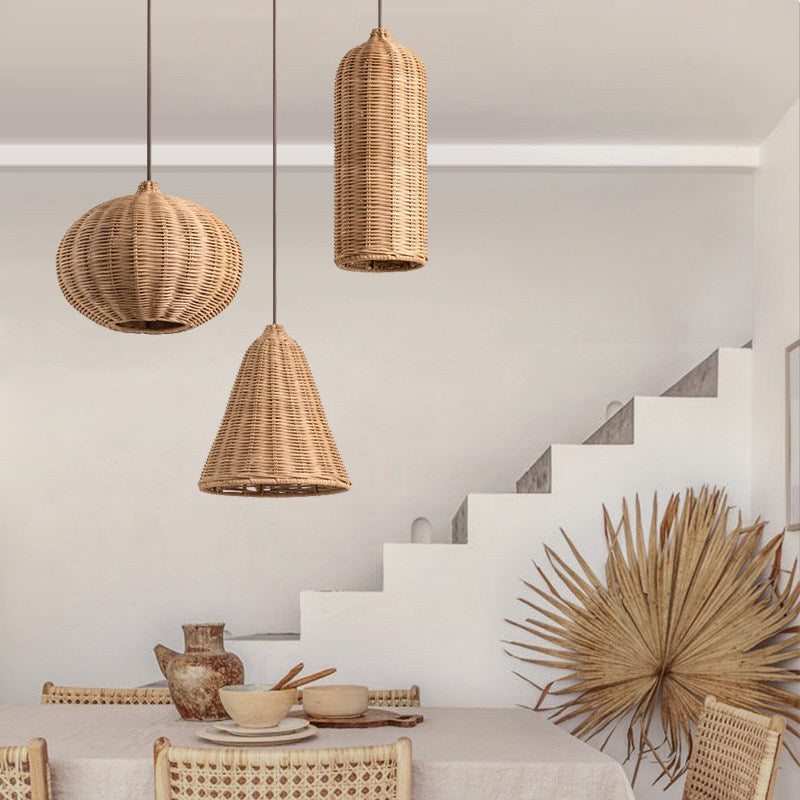 Three rattan Clérachic pendants light a Mediterranean-style stairwell nook styled with a dried palm frond.