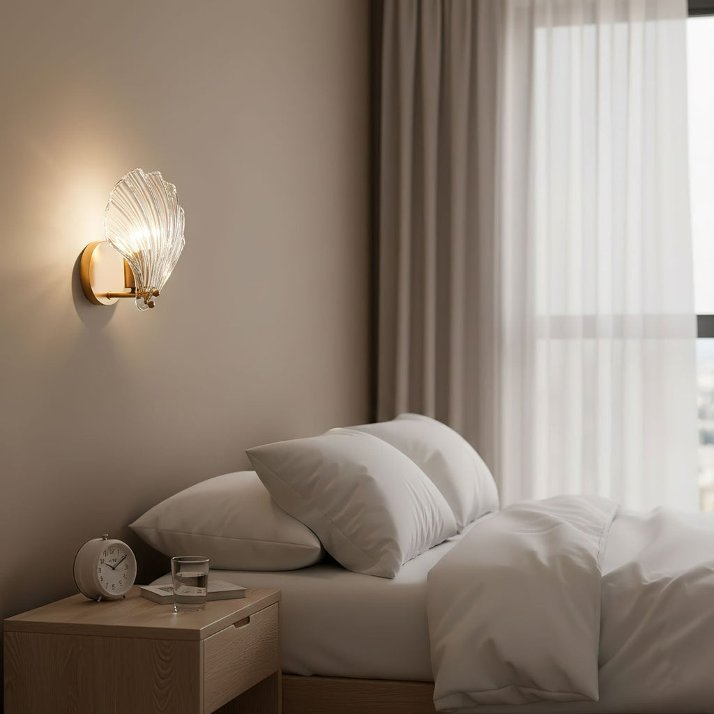 Mounted between sheer-curtained windows, this Clérachic wall light glows softly above a bedside table with an alarm clock.