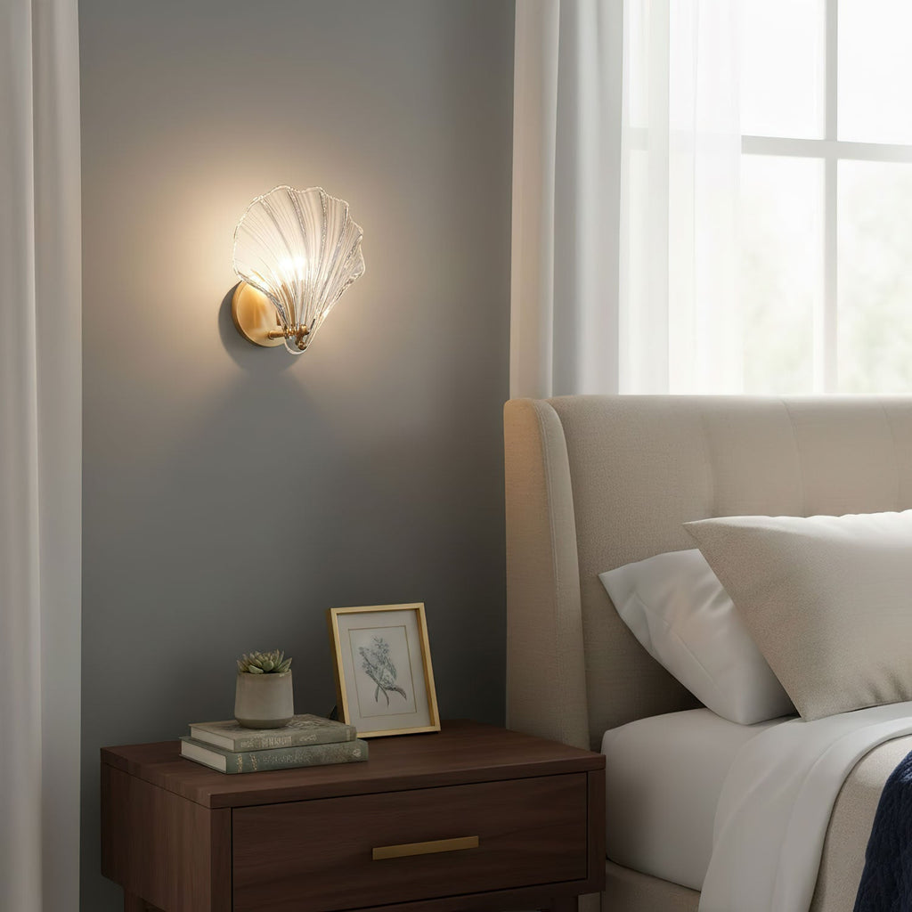 Above a wood nightstand holding a framed photo and a small succulent, this Clérachic wall light glows near a bed.