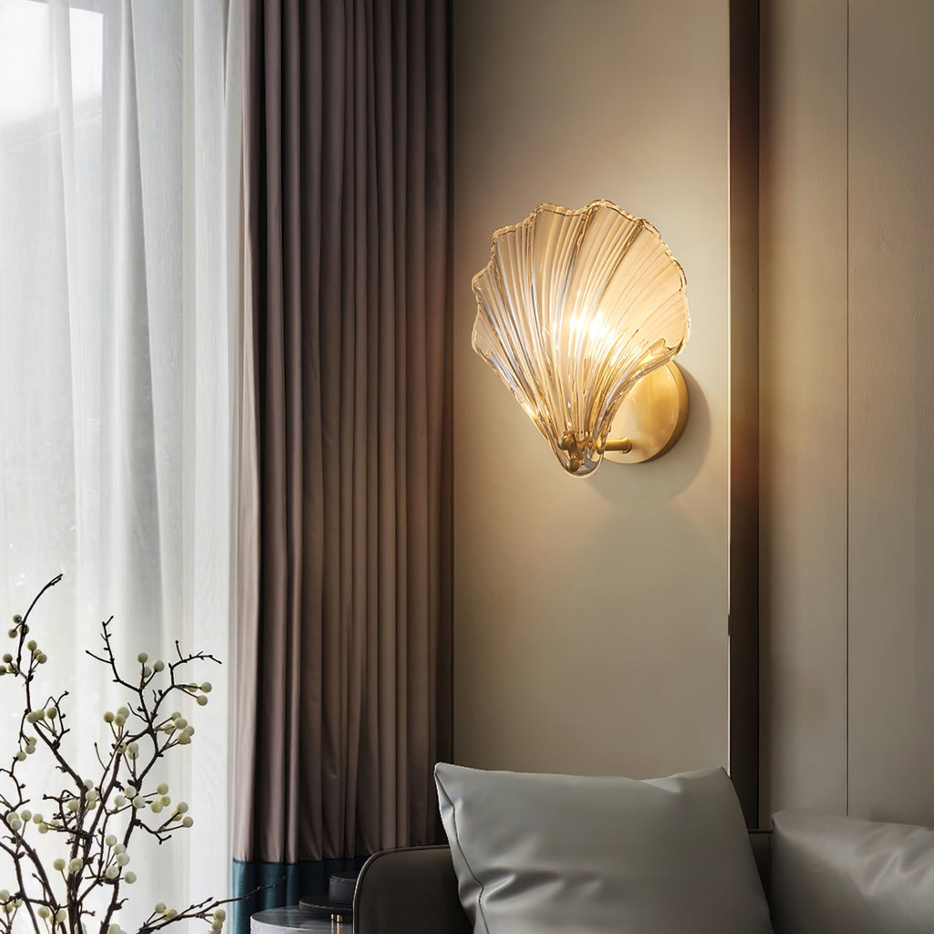 Near a dark curtain and a flowering branch, this Clérachic wall light casts a warm glow across the wall.