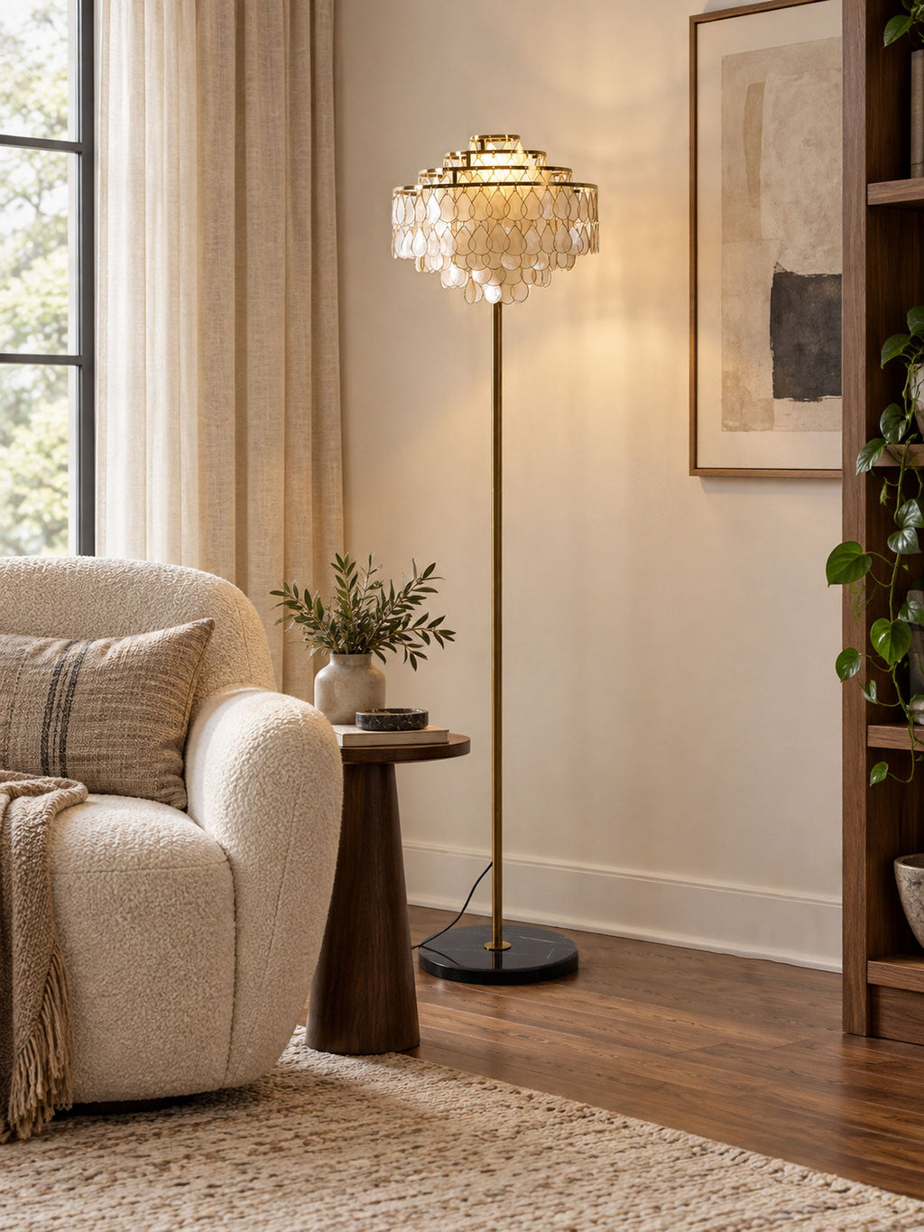A bouclé armchair and a wood side table sit near this Clérachic floor lamp by a curtained window.
