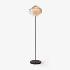Full-length studio view of this Clérachic floor lamp, its tiered shell shade topping a slender gold-toned stem.