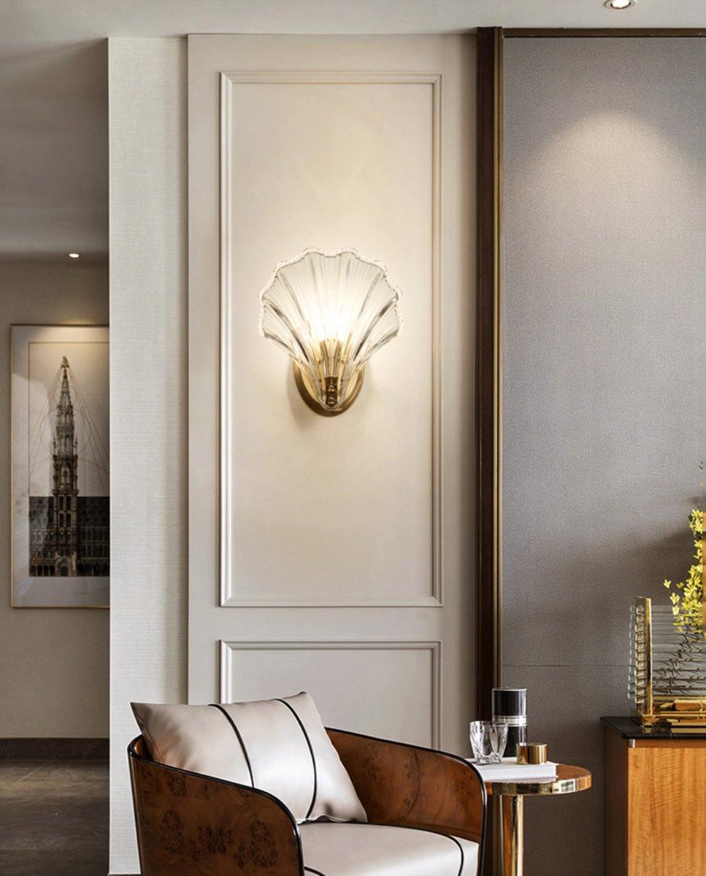 Mounted in a panelled hallway near an armchair and console table, this Clérachic wall light glows softly.