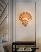 Mounted on a fluted panel wall above a black console table, this Clérachic wall light glows warmly in a hallway.