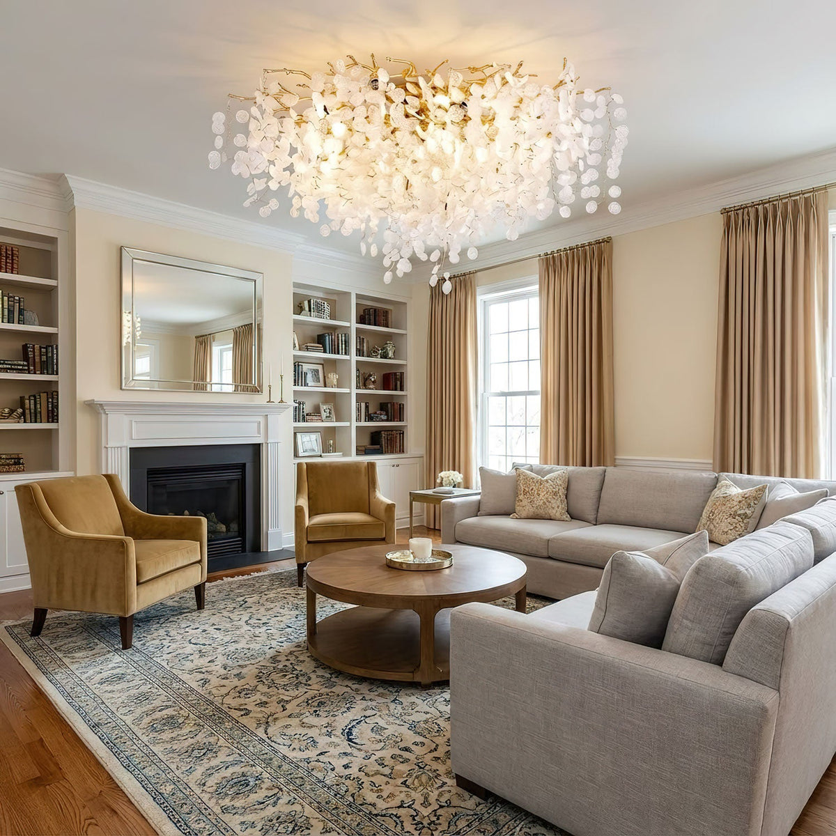 In a living room with built-in bookshelves and a fireplace, this Clérachic ceiling light glows above mustard armchairs and a round coffee table.
