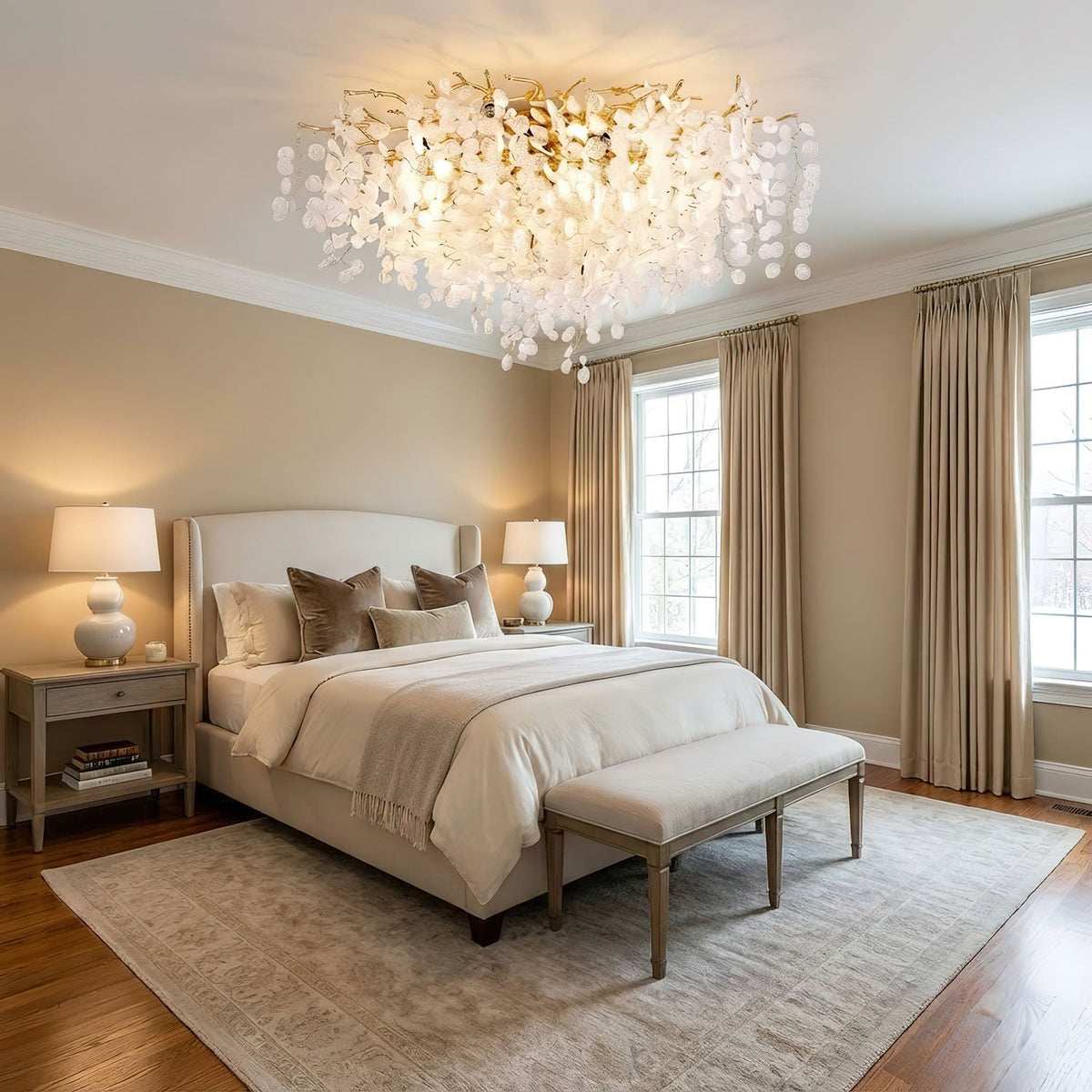 In a bedroom with French doors, this Clérachic ceiling light glows above a bed dressed in neutral linens and a patterned rug.
