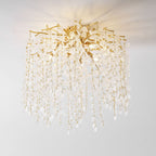 Viewed from an angle against a white background, this Clérachic ceiling light cascades its frosted glass discs from gold branches.