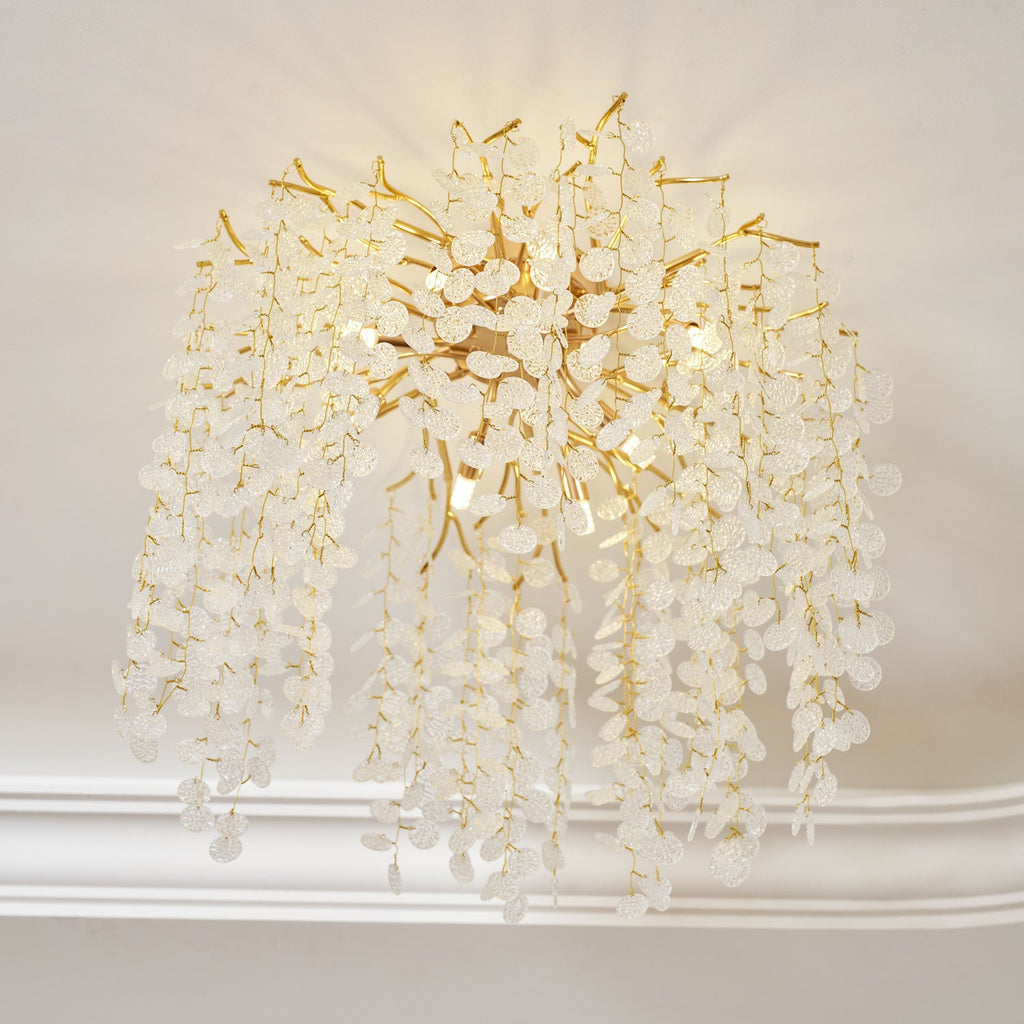 Seen from an angle, this Clérachic ceiling light cascades from a wall-ceiling corner, its frosted glass discs catching the light on gold branches.