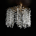 Against a dark background, this Clérachic ceiling light in silver shows its clear glass discs and branches up close.