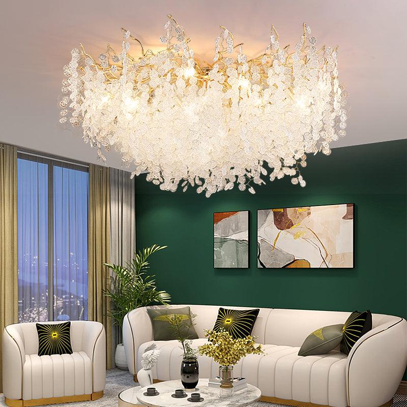 In a living room with dark green walls and abstract art, this Clérachic ceiling light glows above a cream curved sofa.