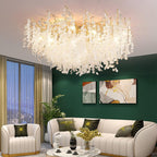 In a living room with dark green walls and abstract art, this Clérachic ceiling light glows above a cream curved sofa.
