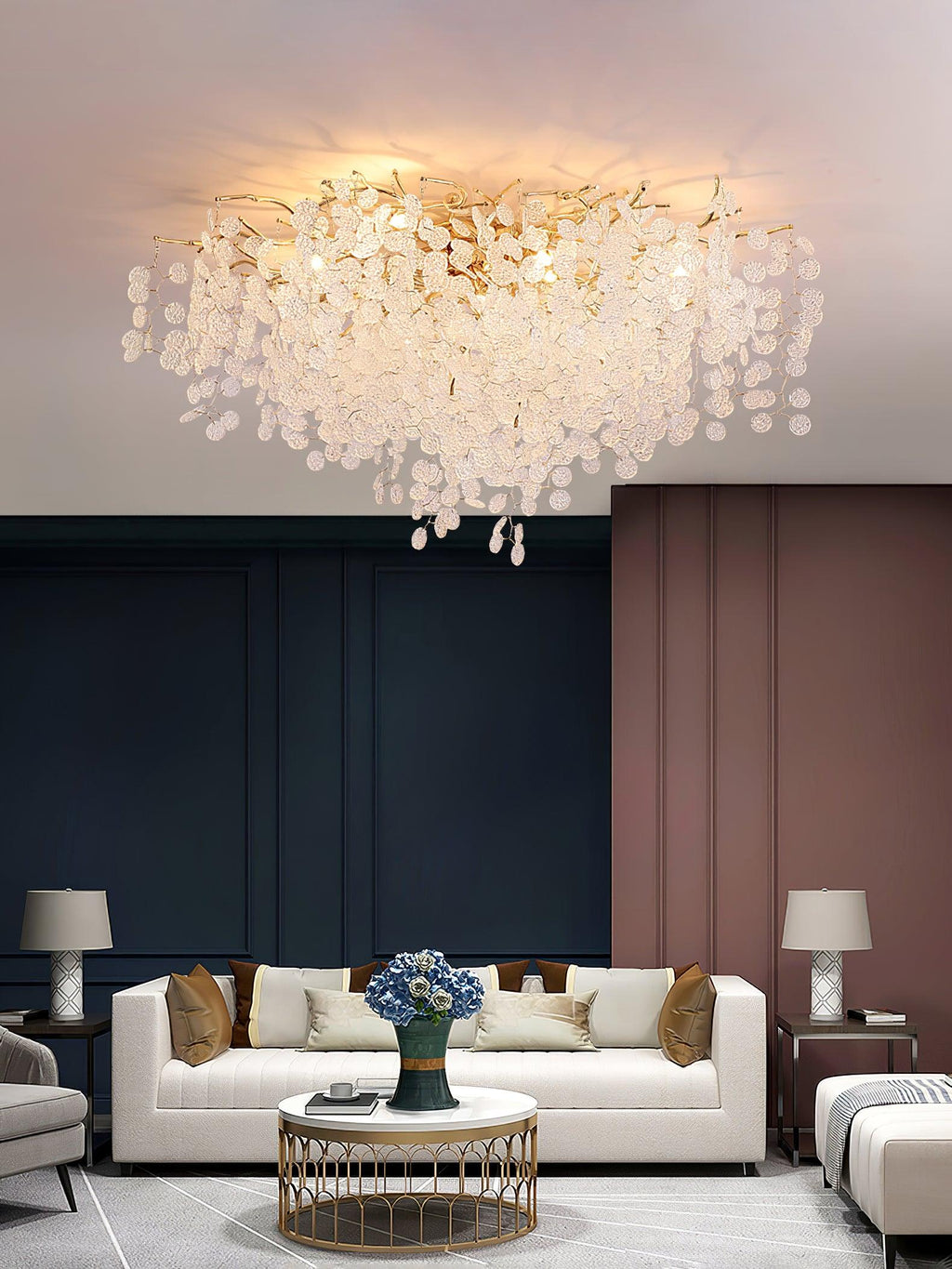 In a living room with navy and dusty-rose panelled walls, this Clérachic ceiling light glows above a white sofa and brass side tables.