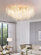 Beside floor-to-ceiling windows overlooking greenery, this Clérachic ceiling light glows above a beige sofa and armchair.