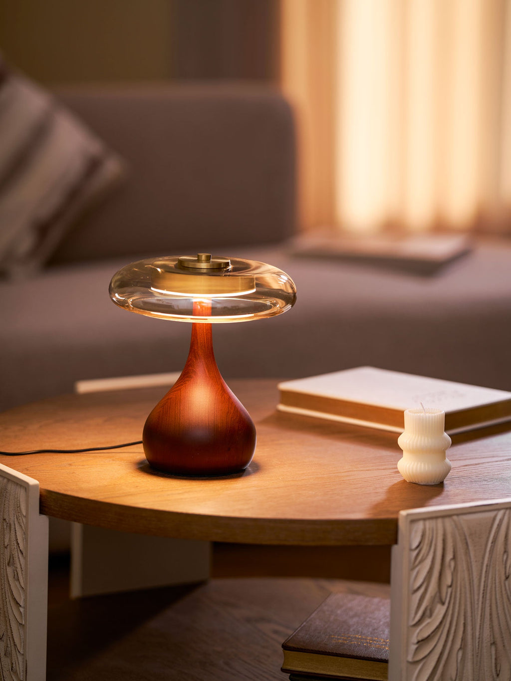 Amber glass table lamp styled on a bedside table at night