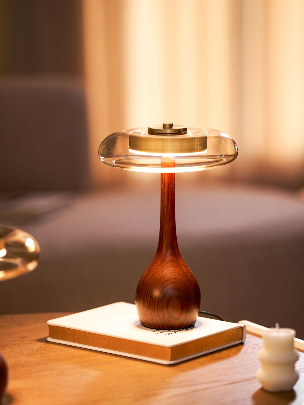 Amber glass table lamp glowing softly in a relaxed corner